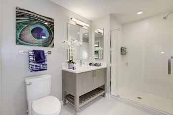 A bathroom with a toilet sink and shower 